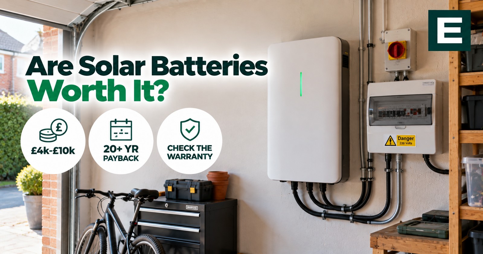 A wall-mounted home battery in a British garage, wired to a consumer unit and isolator